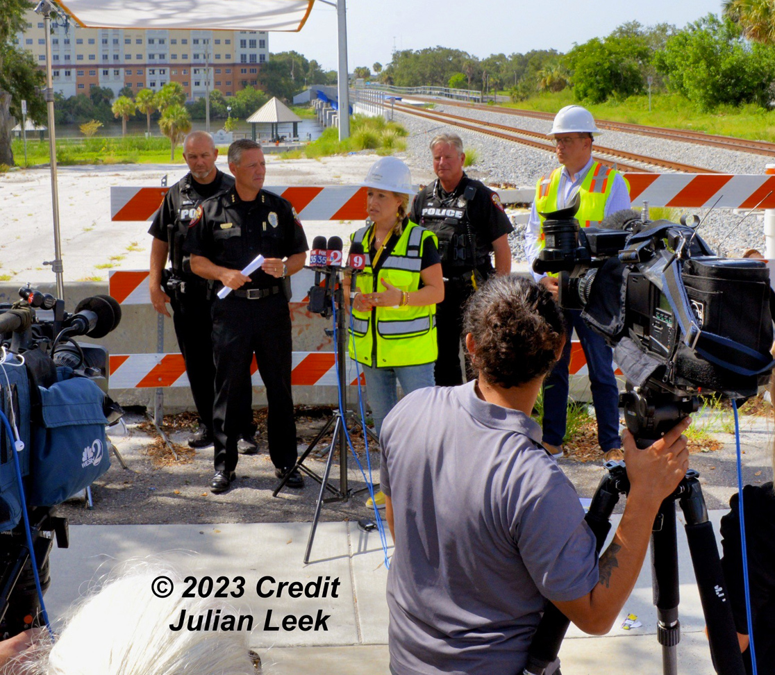 Brightline PR and Safety partner with Melbourne PD at a press conference in front of railroad tracks